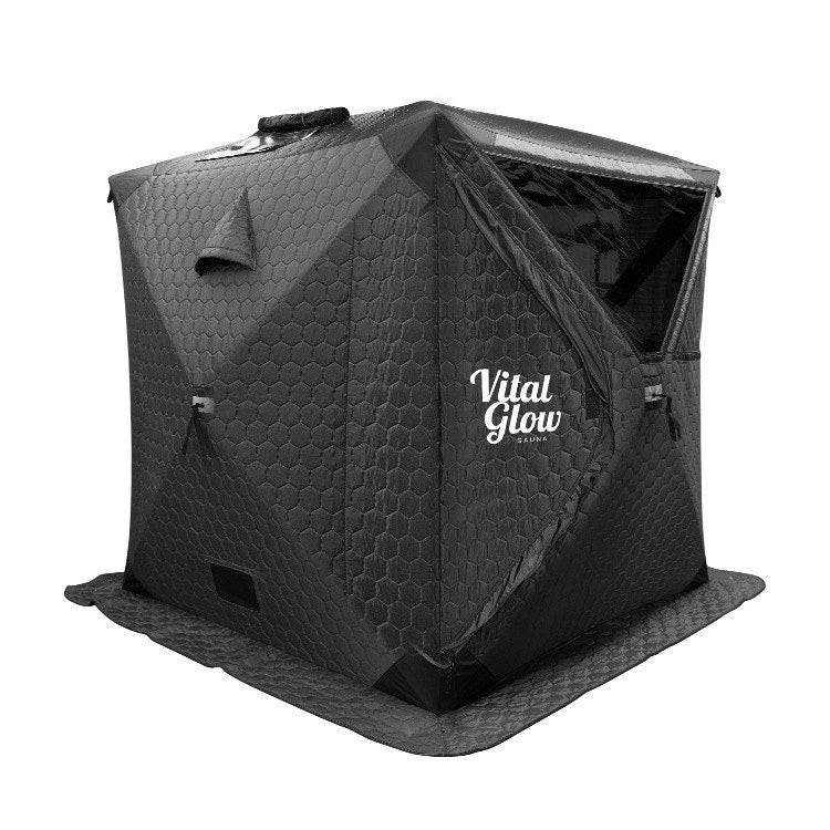 A black Vital Glow wood-burning sauna with a visible brand logo on the side.