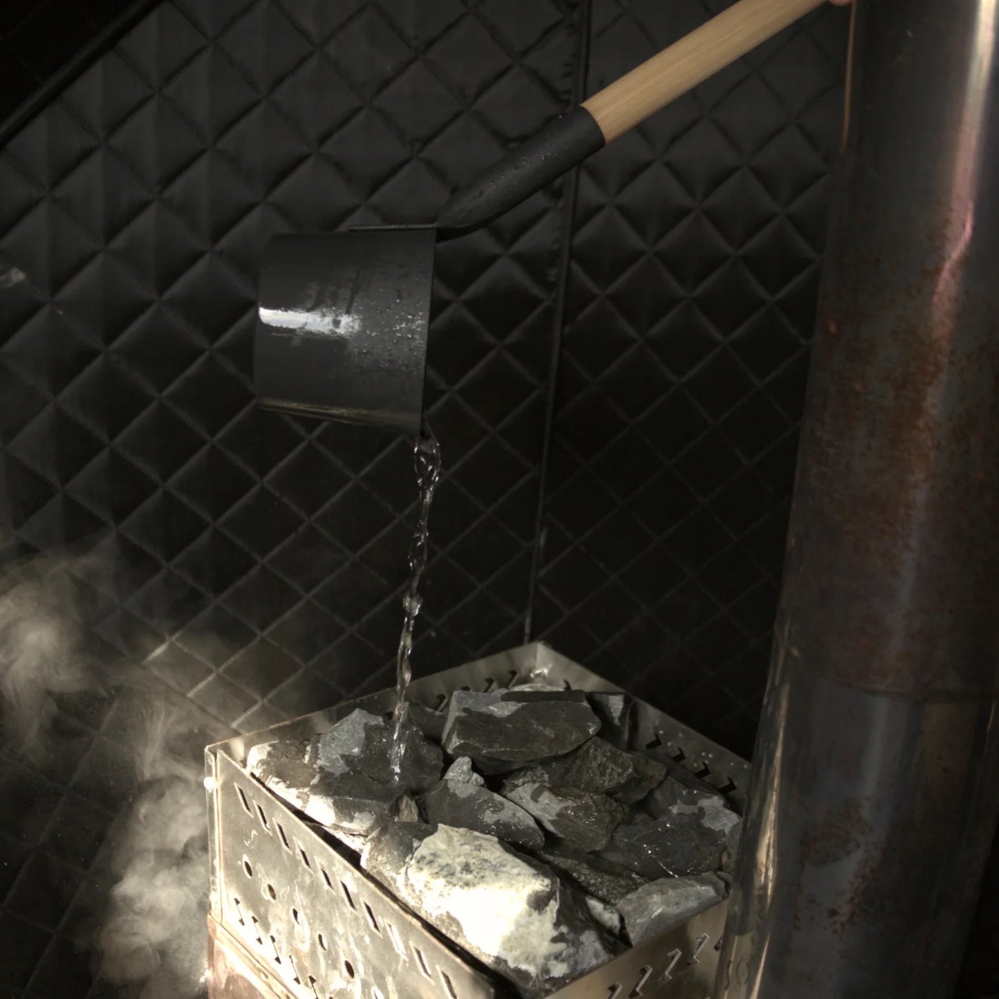 Sauna rocks with water pouring over to create steam