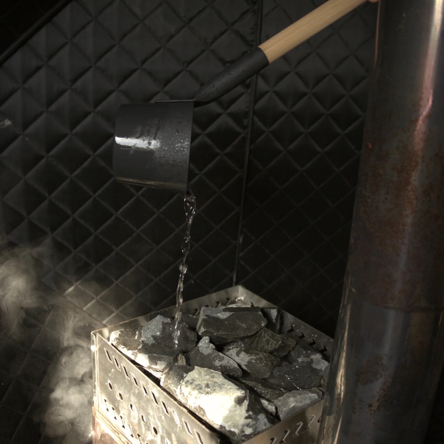 Sauna rocks with water pouring over to create steam
